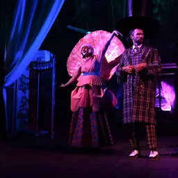 Costumed theatre performers on stage